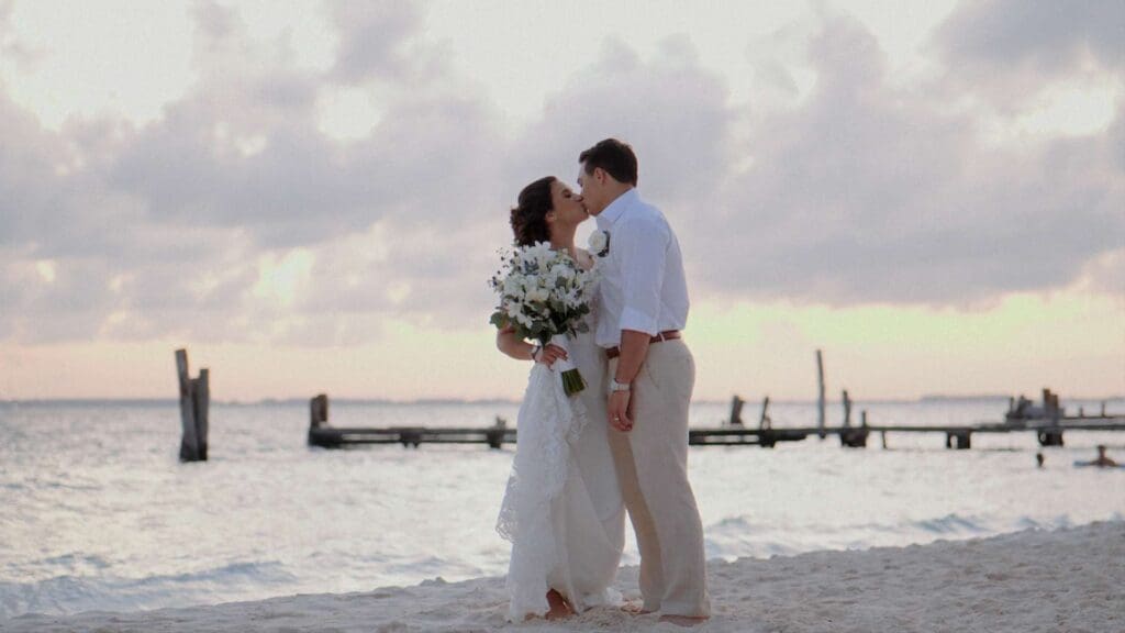 Romantic kiss in a cloudy-day destination wedding film